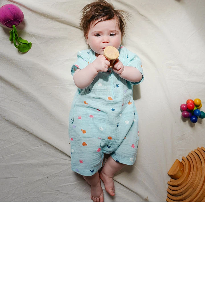 Flat knitted baby boys' romper suit in light blue with printed pattern