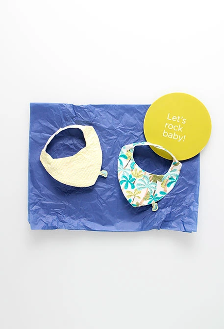 Lot de 2 bavoirs en tricot pour bébé en couleur jaune avec motif végétal.
