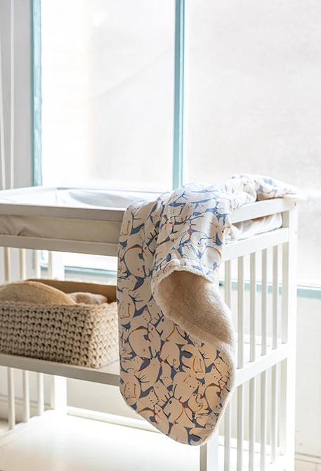 Baby blanket in printed blue and beige animal fleece.