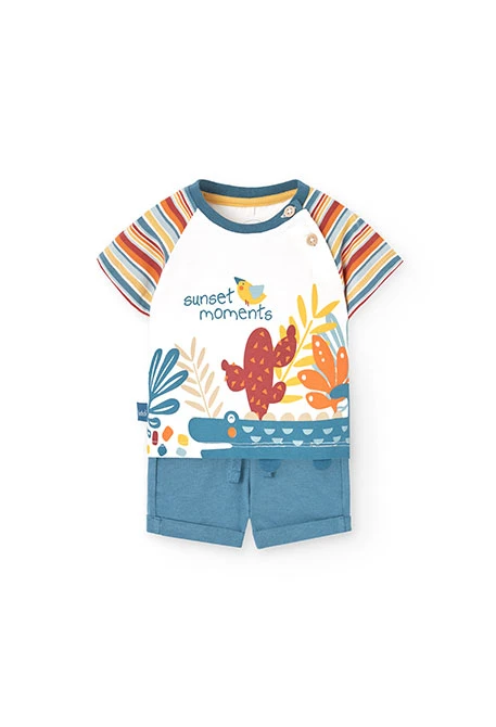 Ensemble t-shirt et pantalon en maille pour bébé garçon de couleur blanche avec motif.