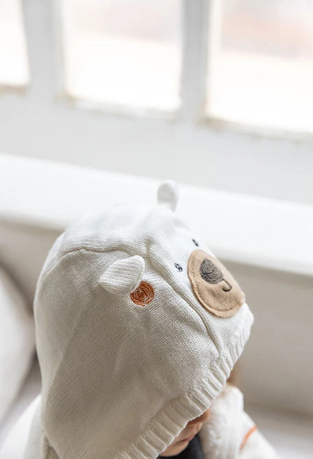 Knitted baby jacket in white
