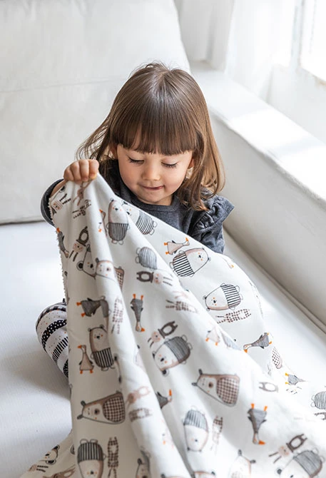 Knitted baby blanket with animal print