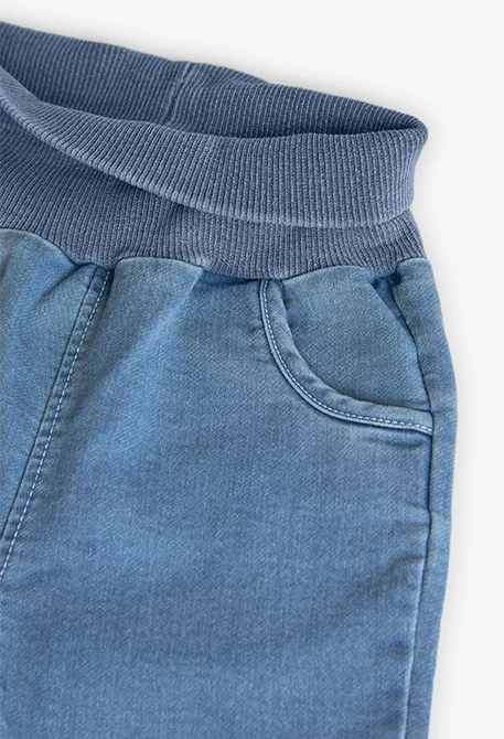 Set di maglietta e pantaloni in maglia per neonato di colore bianco.
