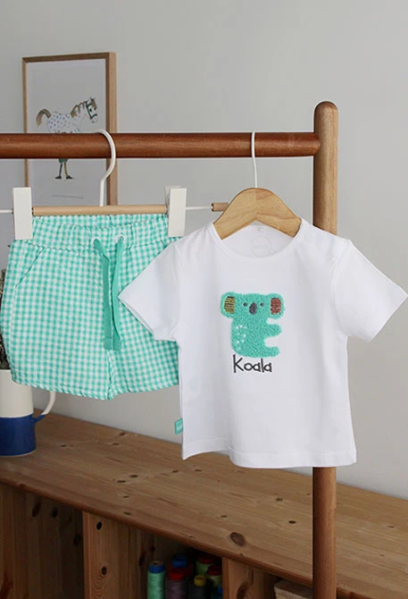 Nursery set with a koala design in white for baby boys.