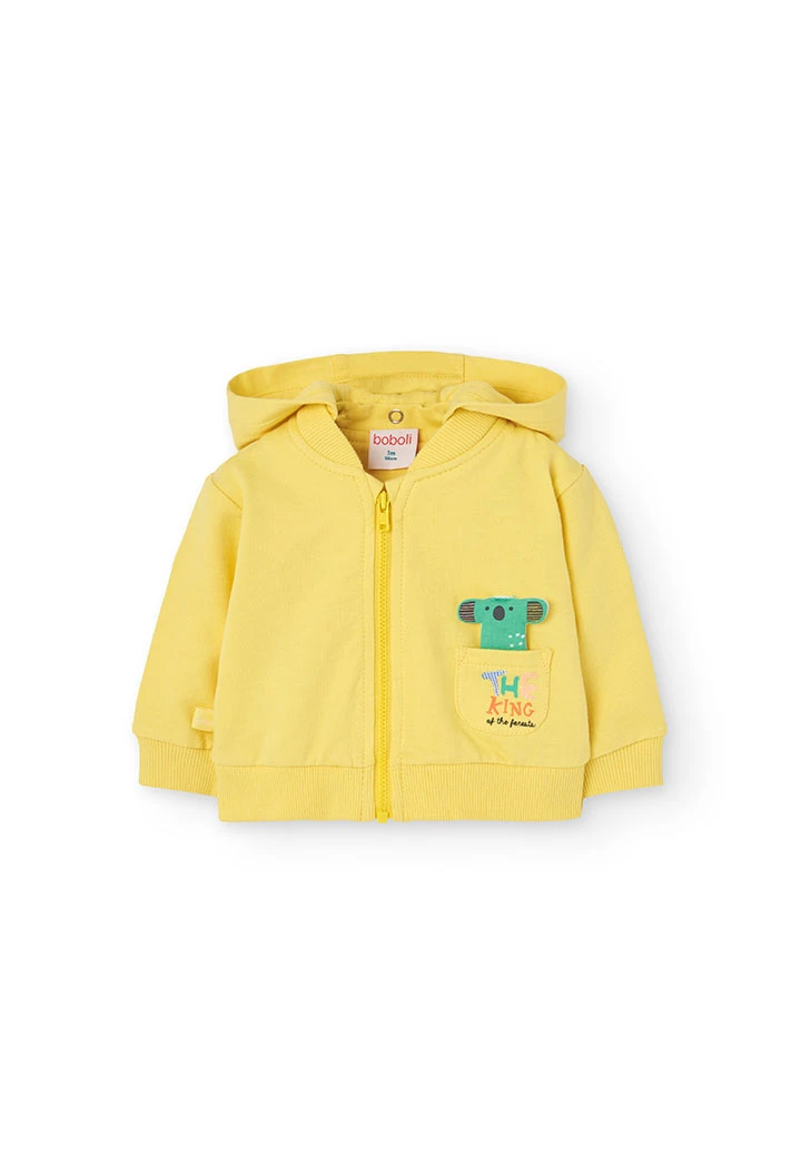 Cardigan per neonato di colore giallo.