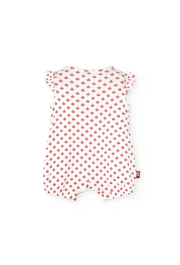 Combinaison en tricot pour bébé fille de couleur blanche avec un motif de fleurs rouges.