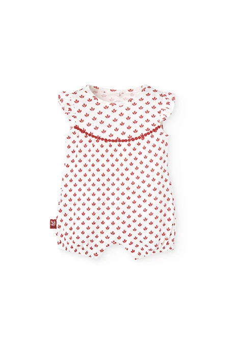 Combinaison en tricot pour bébé fille de couleur blanche avec un motif de fleurs rouges.