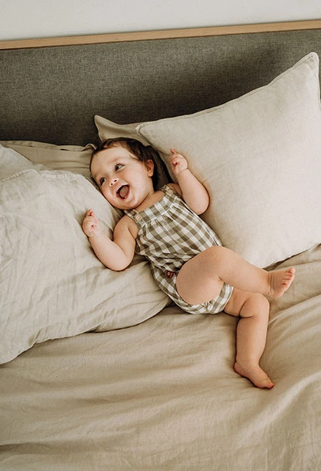 Romper for baby in checkered earth tones