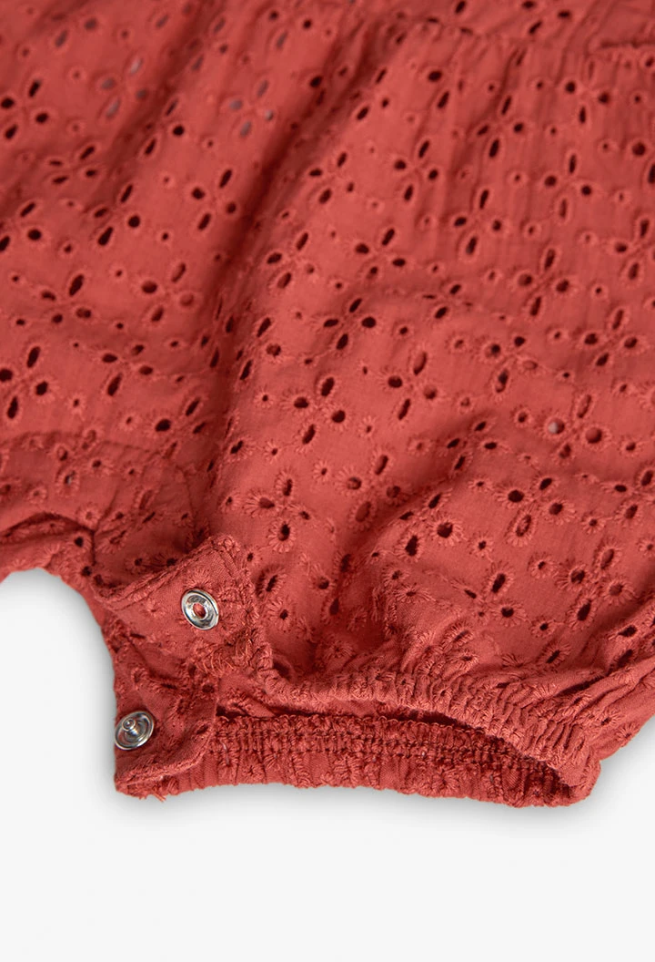 Tutina a maglia per bambina in colore arancione ricamata