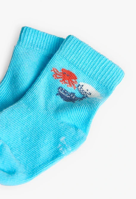 Babypack mit Stricksocken in Blau