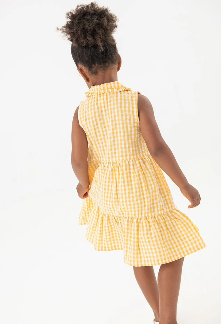 Baby girl\'s poplin dress with a yellow check pattern.