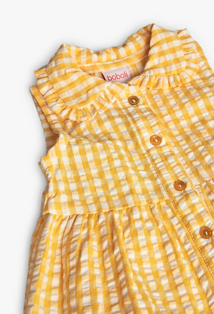 Baby girl\'s poplin dress with a yellow check pattern.