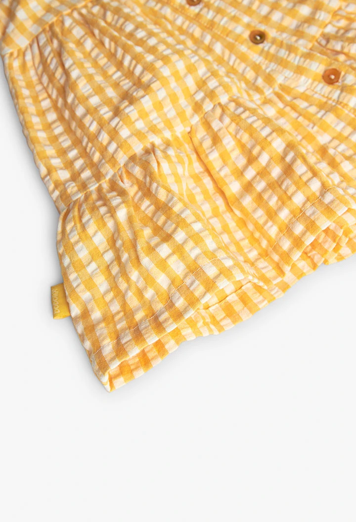 Baby girl\'s poplin dress with a yellow check pattern.