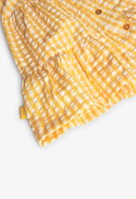 Vestito di popeline per neonata con stampa a quadri di colore giallo.