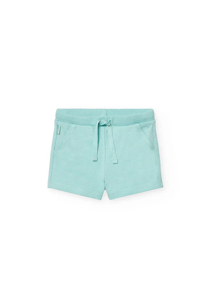 Completo di maglietta e pantaloncini a maglia per neonata di colore bianco.