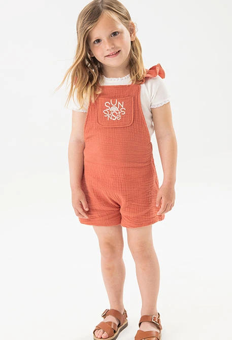Knitted jumpsuit for baby girl in orange.