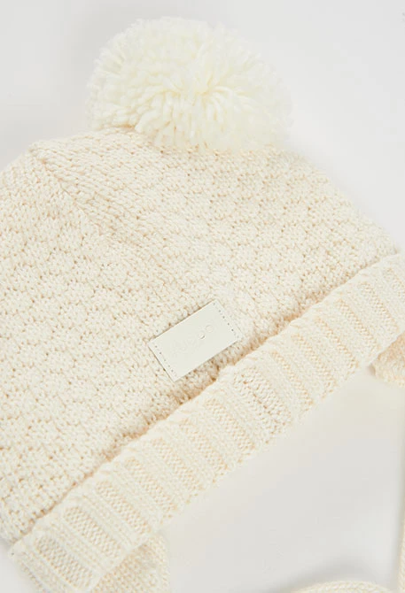 Weißes Babymütze mit Pompons