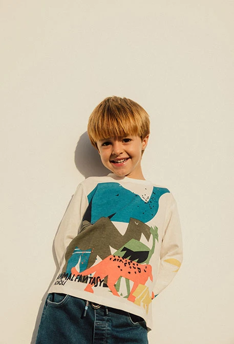 Maglietta a maglia per bambino in colore bianco con motivo di dinosauri
