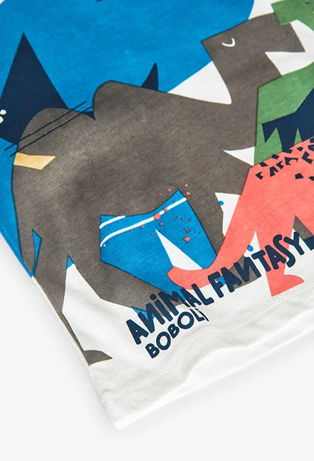 T-shirt en tricot pour bébé garçon de couleur blanche avec un motif de dinosaures.