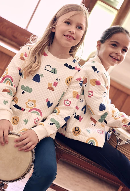 Girl\'s cream knitted jacket with multicolour print