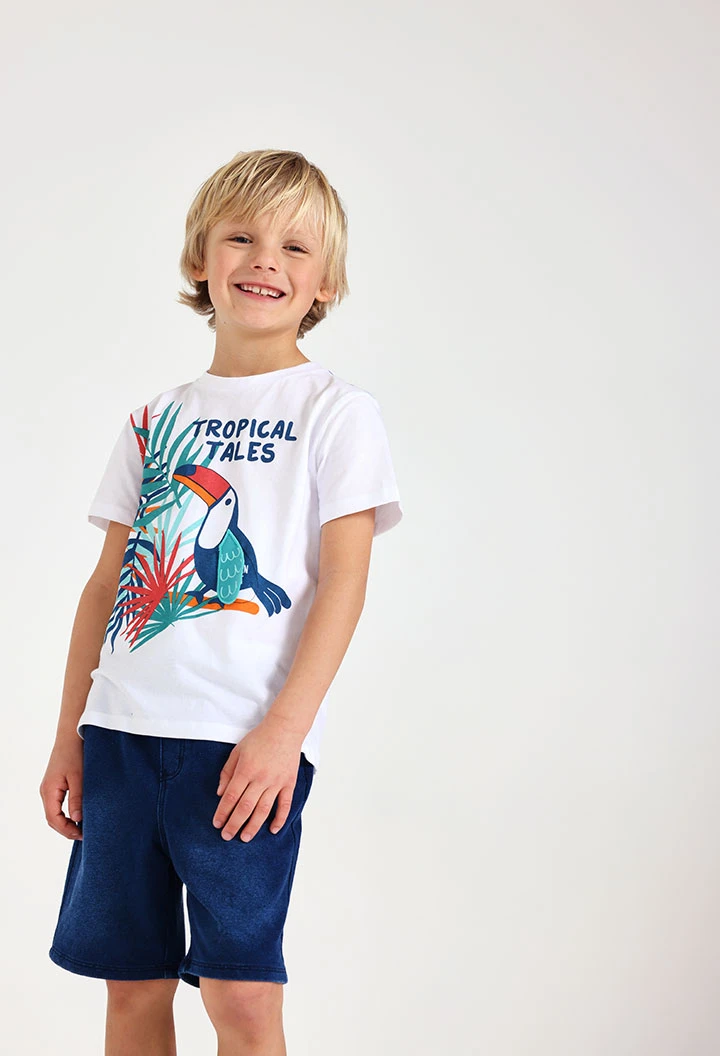 Maglietta in jersey per bebè maschio di colore bianco con stampa tropicale.