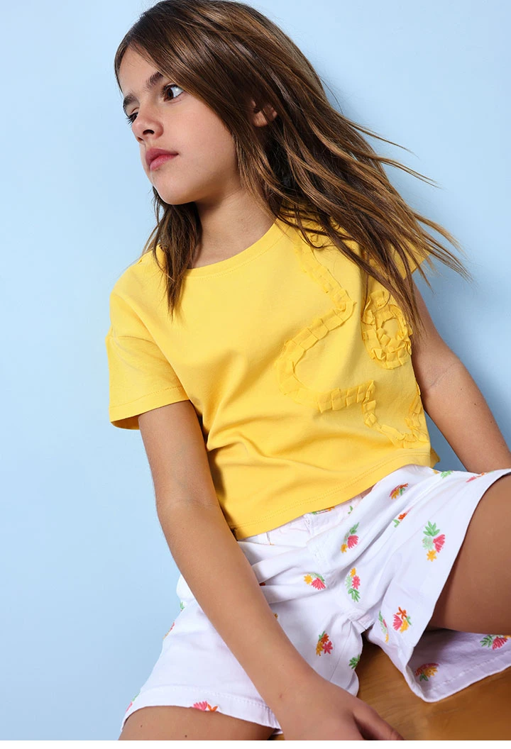 Bermuda en maille pour fille en blanc avec un motif de fleurs