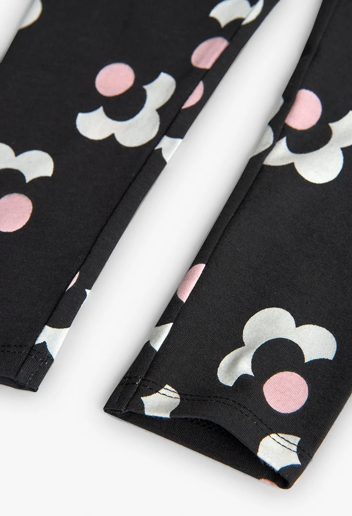 Black, pink, and white floral knit leggings