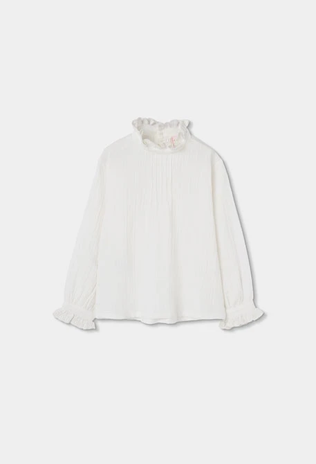 Blouse en mousseline blanche avec volants et col froncé