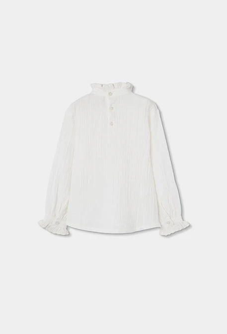 Blouse en mousseline blanche avec volants et col froncé