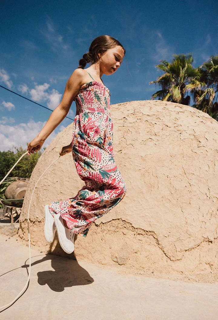Girl\'s knit jumpsuit with floral and leaf print in pink.