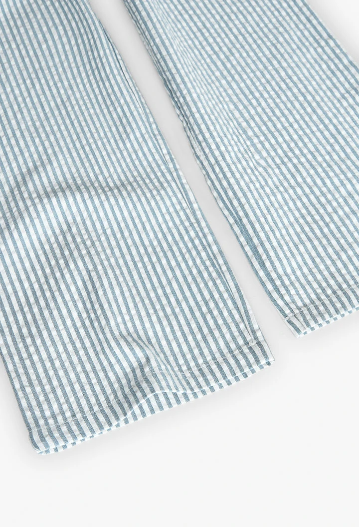 Tuta in popeline per bambina a righe in blu e bianco.