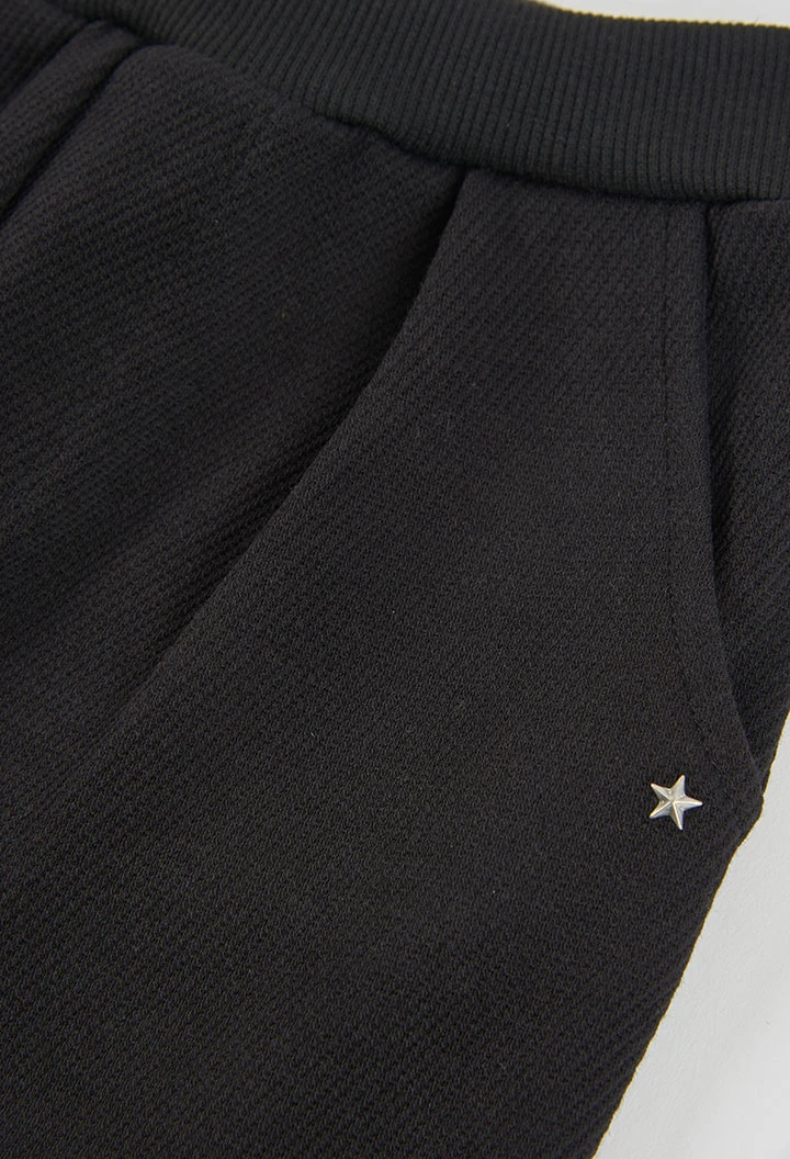 Black star print knitted trousers for girls