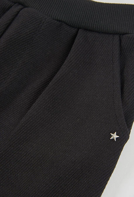 Pantalone in maglia da bambina nero con stelle