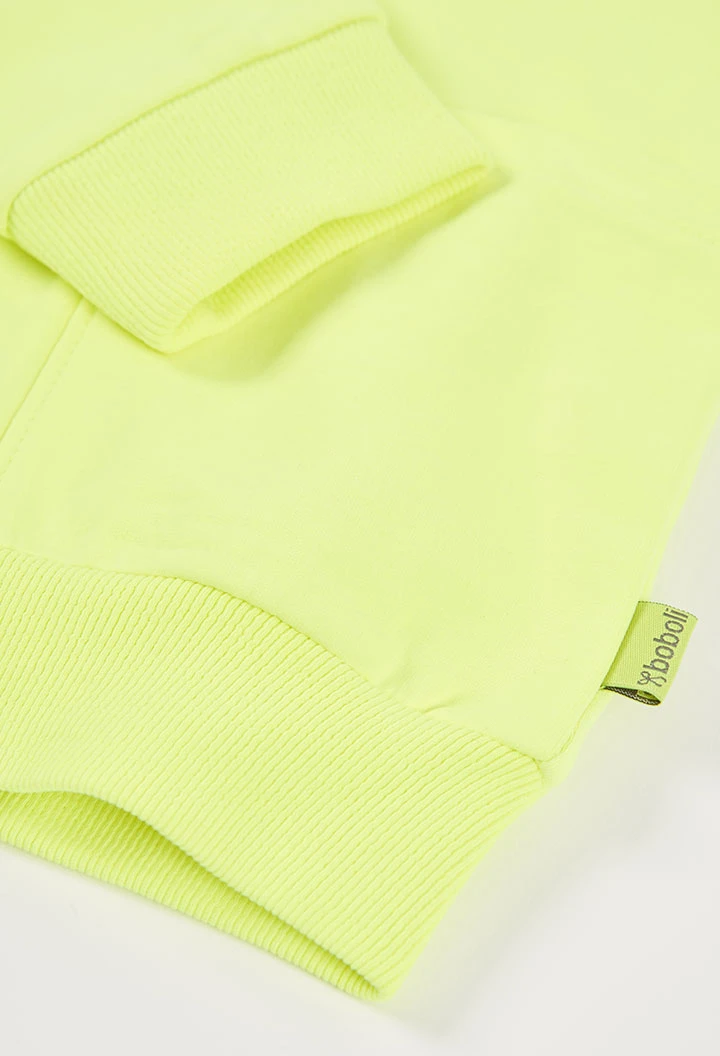 Jaqueta nena amb caputxa en verd fluor