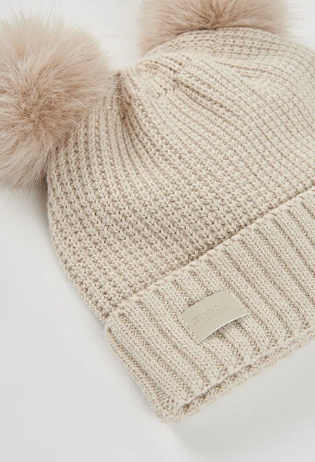 Beige hat with double pompoms