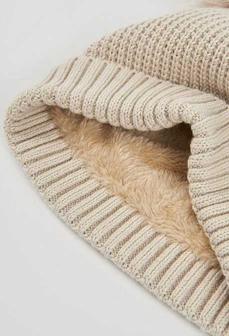 Beige hat with double pompoms