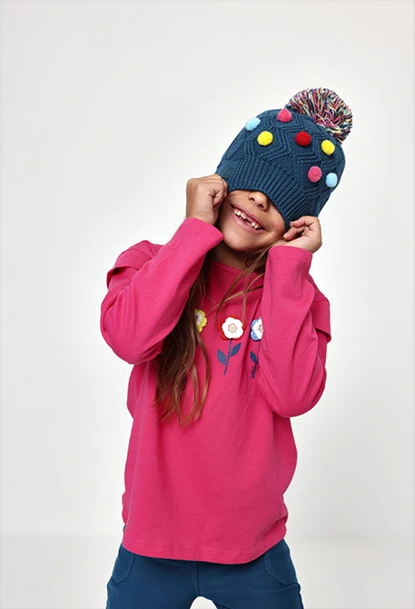 Green hat with coloured polka dots