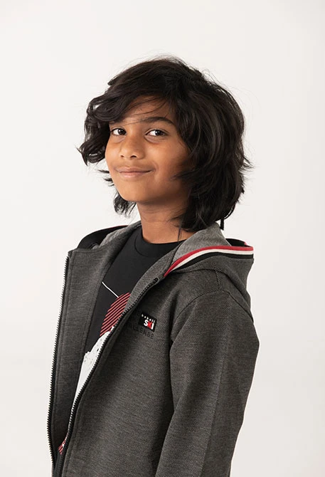 Black knit boy´s jacket with red and white trim