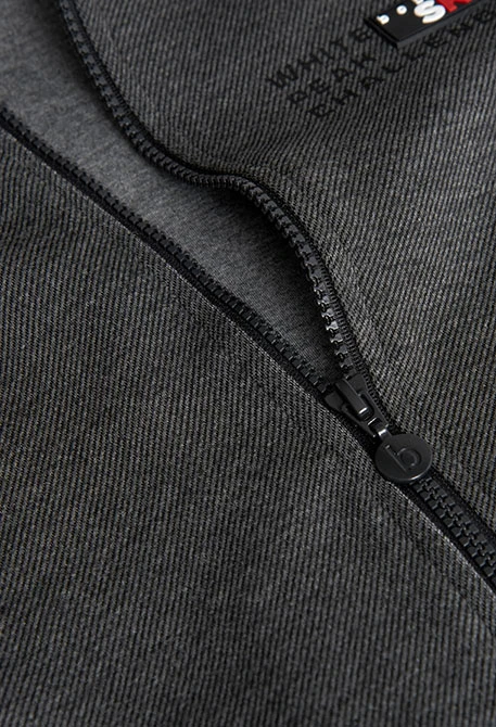 Veste garçon en maille noire à bordure rouge et blanche