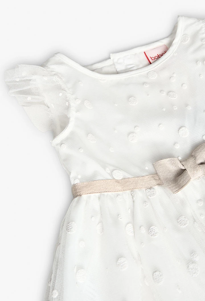 Robe en tulle pour bébé fille avec motif à pois en couleur blanche.