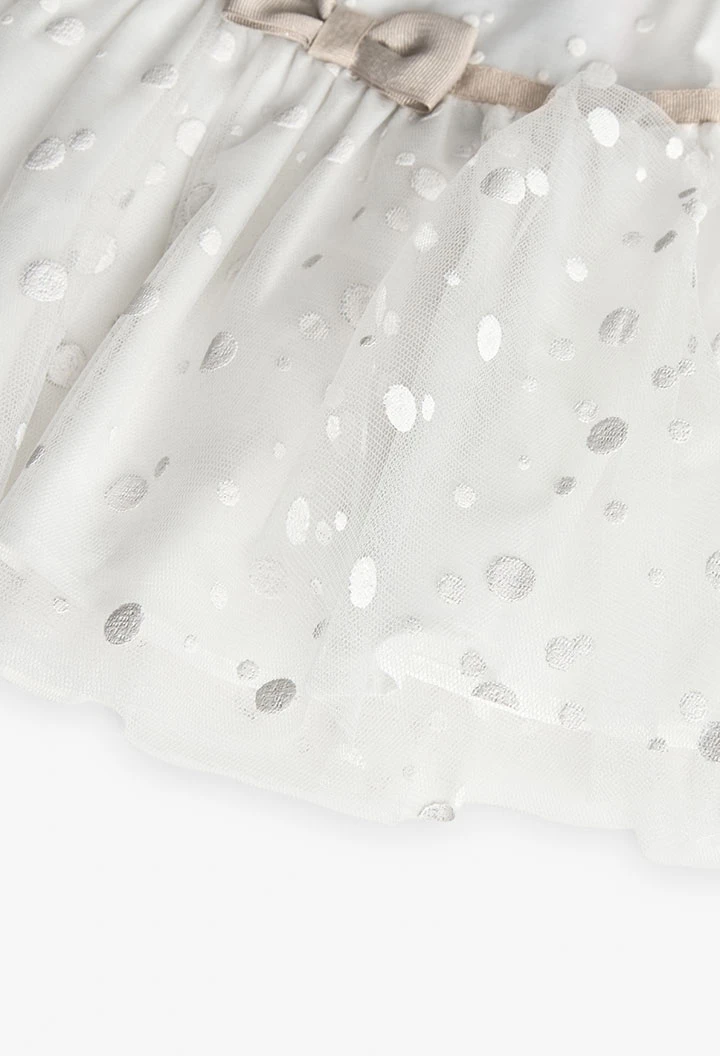 Robe en tulle pour bébé fille avec motif à pois en couleur blanche.