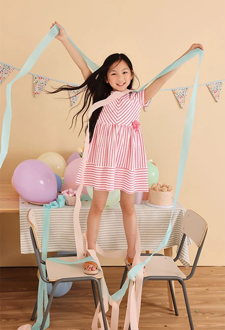 Baby girl's knitted dress with pink and white stripe pattern