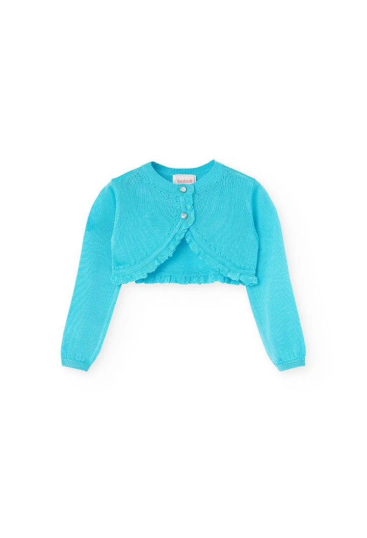 Boléro en tricot pour bébé fille de couleur bleue.