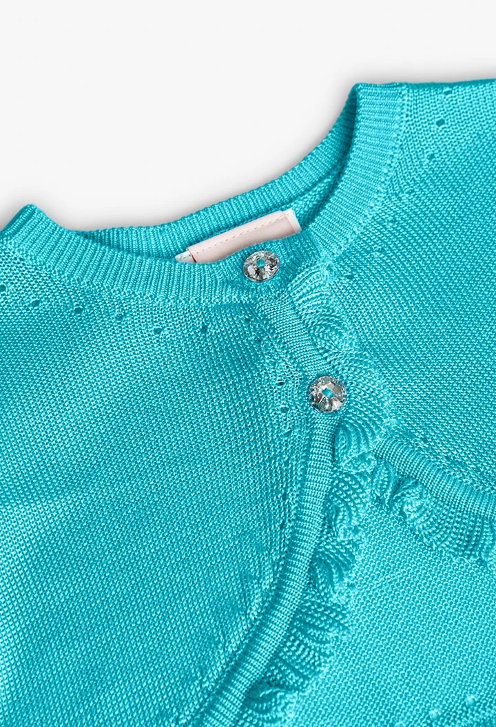 Boléro en tricot pour bébé fille de couleur bleue.
