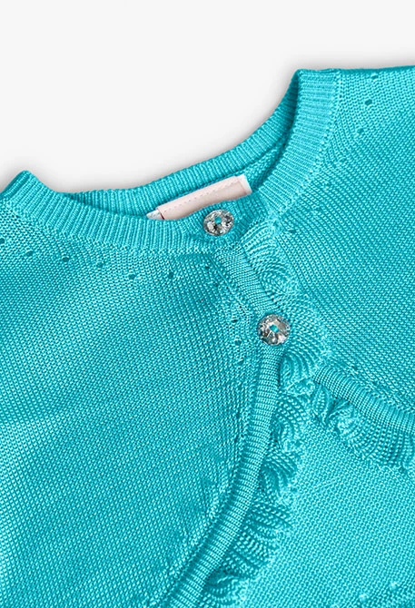 Boléro en tricot pour bébé fille de couleur bleue.