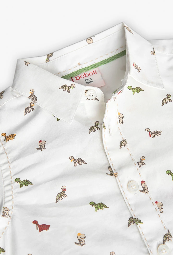 Chemise en popeline pour bébé imprimée de couleur blanche avec motif de dinosaures.