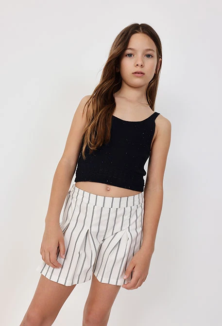 Knitted skort for girls with a black and white stripe pattern