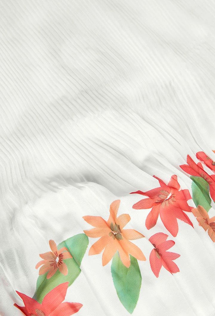 Robe en mousseline plissée pour fille de couleur blanche.