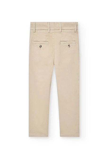 Pantaló de setí per a nen en color beige.
