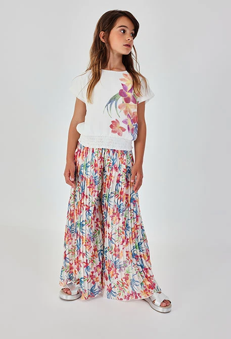 Calça estampada de folhas boca de sino para menina